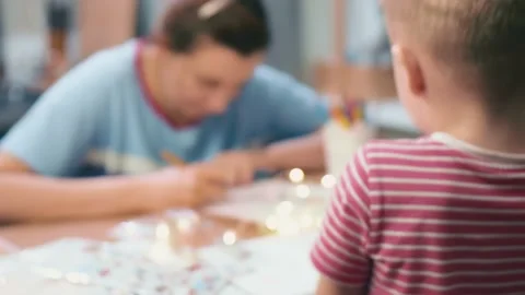 Moms and son are preparing for the new year and Christmas learn to draw Santa Stock Footage 157178470