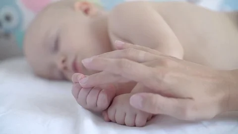 Mom's handles gently stroking sleeping baby on the handles. Slow motion Stock Footage 80325432