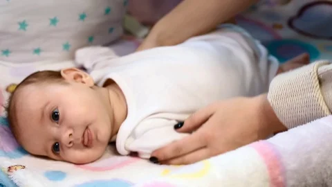 Mom's hands doing massage newborn baby Stock Footage 107337451