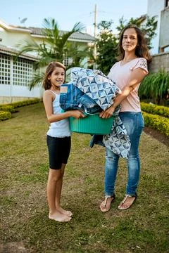 Moms laundry apprentice. Portrait of a mother and daughter hanging up laundry Stock Photos