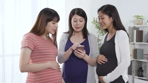 Moms standing together and looking at information Stock Footage 139608373