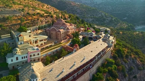 Monastery built on a rocky cliff above a coastal bay Видео 341329229