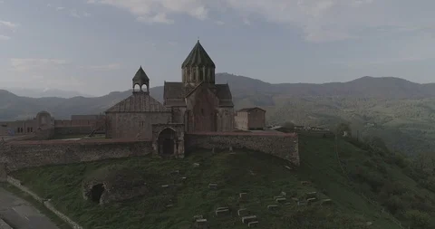 Monastery Gandzasar. flowering tree. vertical pan. unveiling shot. 426 214547 3 Stock-Footage 90104021
