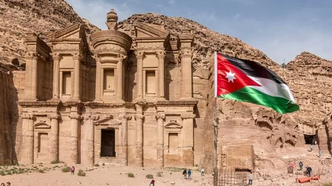The Monastery or Ad Deir in ancient city of Petra. Jordan flag waves in the wind Stock Footage 108815077