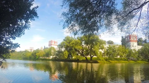 Monastery on the shore of a pond timelapse Stock Footage 81605682