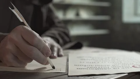 Monastic copyist in a brown robe copying Latin text with a quill pen 스톡 동영상 339631326