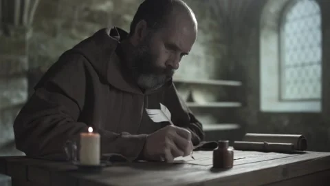 Monastic scribe in a brown habit writing a manuscript with a feather pen Stock Footage 340079489