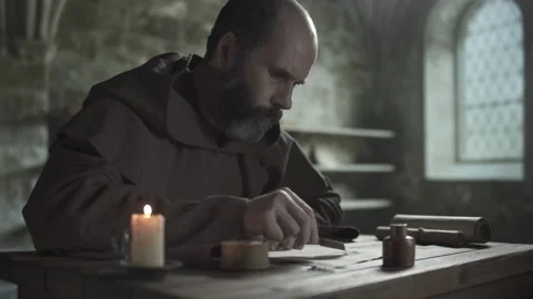 Monastic scribe finishing calligraphy lines and sprinkling sand, medium shot Stock Footage 339232739