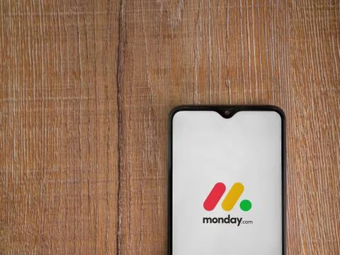 Monday app launch screen with logo on the display of a black mobile smartphon Stock Photos