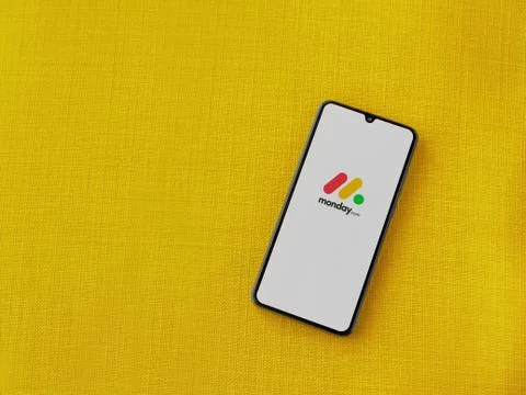 Monday app launch screen with logo on the display of a black mobile smartphon Stock Photos