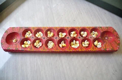 Monetaria moneta shells or Money cowry shell in wooden red tray for malaysian Stock Photos