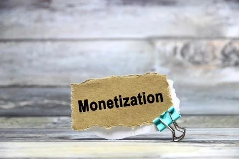 Monetization wording or text on brown paper with grey background.Copy space.. Stock Photos