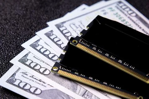 Money and computer memory stacked together on a black surface during the day in 写真素材
