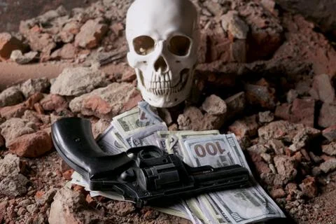 Money and a revolver near the skull. Criminal concept Stock Photos