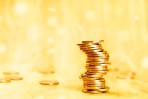 Money background, a stack of coins on an abstract golden texture with copy space Foto stock