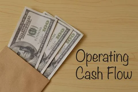 Money banknotes on the table with text OPERATING CASH FLOW Stock Photos