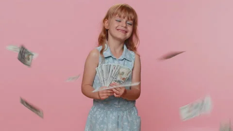 Money cash dollar rain falling on child girl kid celebrating success, winning Stock Footage