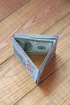 Money in cash in in triangular shape. Hundred dollar notes Stock Photos