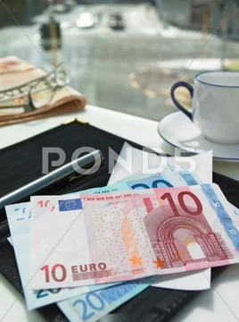 Money In Check On Restaurant Table
