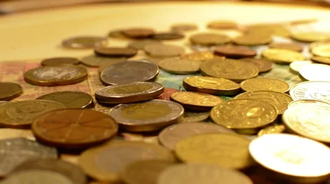 Money coins and bills are rotated on a wooden stand Stock Footage 59666663