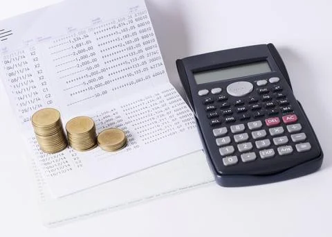 Money coins stack and calculator and book baank loan money concept Stock Photos