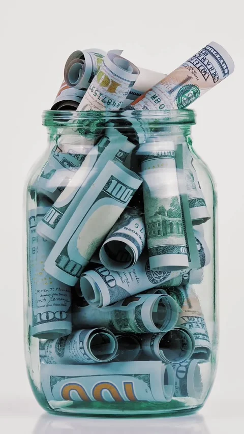 Money. dollar bills. close-up. rotation. rolled hundred dollar bills in a glass Stock Footage 320304432