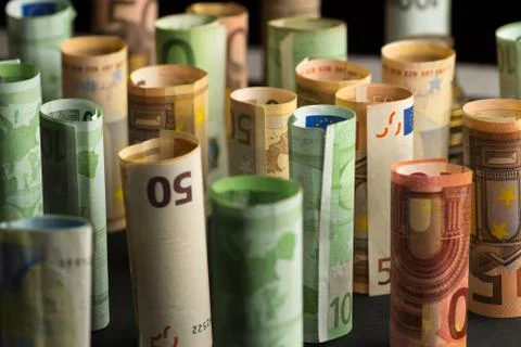 Money euro banknotes in rolls in a dark background Stock Photos
