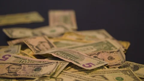Money Falling into a Pile on a Table Stock Footage 94158774