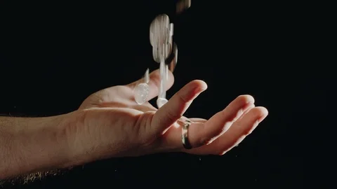 Money falling through the fingers of a hand, trying to hold on to it. Stock Footage 101564292
