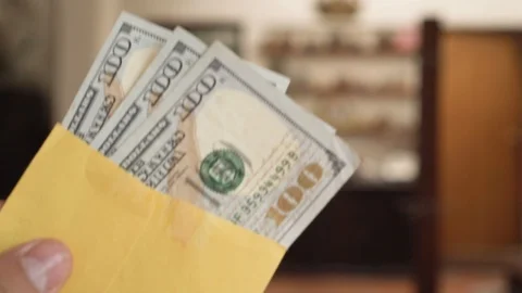 Money -  Hands holding an envelope with $100 dollar bills Stock Footage 123730683
