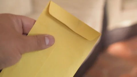 Money - Hands holding an envelope with $1000 pesos bills  Stock Footage 123735336