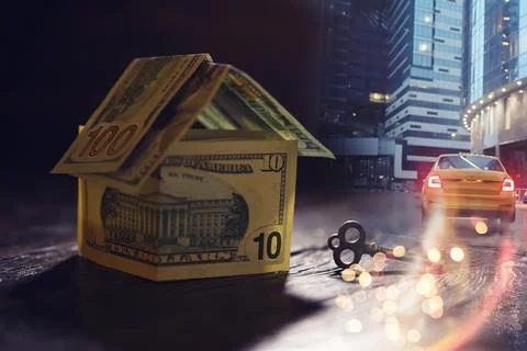 Money house on stack of dollar bills on wooden table, close up. Double expo.. 스톡 사진
