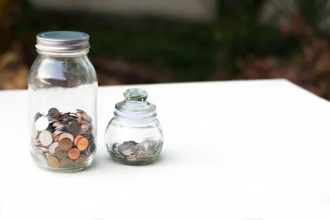Money in a jars Stock Photos