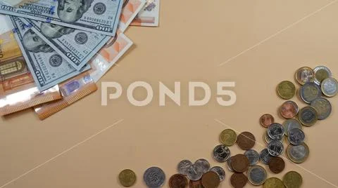 Money lying on yellow backgroud. Coins and bills concept of success Stock Photos