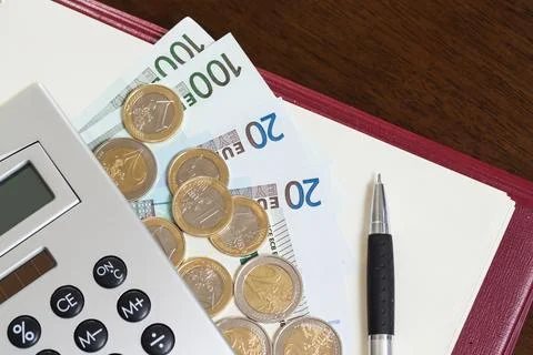 Money, notepad and calculator on the table Stock Photos