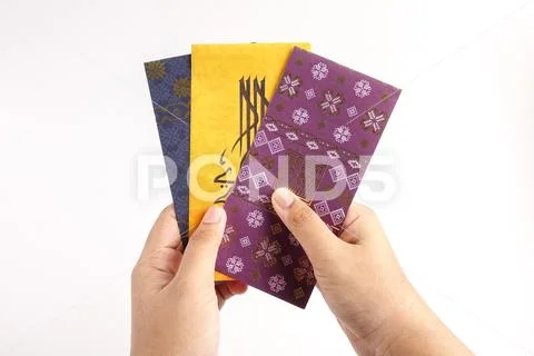 Money packet during Eid Fitr on white. Arabic characters means Happy Eid Muba Stock Photos