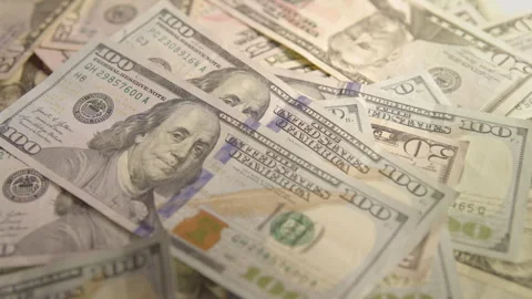 Money piling up in large denominations 4k Stock Footage 324877109