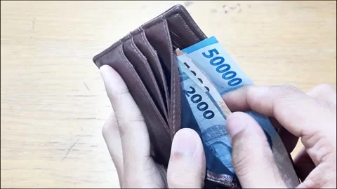 Money pulling out rupiah note from a wallet Stock Footage 288975624