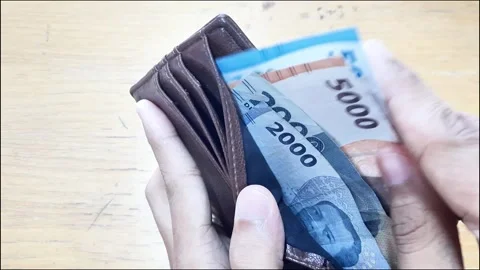 Money pulling out rupiah note from a wallet Stock Footage 288975652