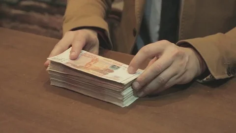 Money rubbles on a table Видео 79159427