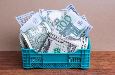 Money stack in basket Stock Photos