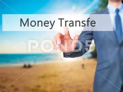 Money Transfer - Businessman click on virtual touchscreen. Stock Photos