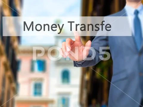 Money Transfer - Businessman click on virtual touchscreen. Stock Photos