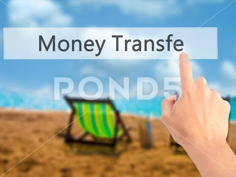 Money Transfer - Hand pressing a button on blurred background co Stock Photos
