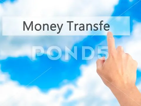 Money Transfer - Hand pressing a button on blurred background co Stock Photos