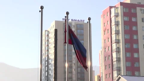 Mongolia flag waving in the wind with high buildings in the background Stock Footage 239900507