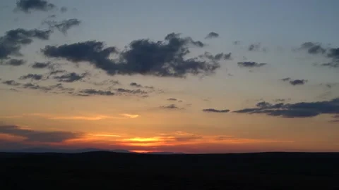 Mongolia steppe sunset spreads orange light - Twilight Colors and Mountain Peak Stock Footage 339646413