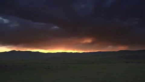 Mongolia sunset glows above grassland hills - Rolling Plains and Evening Colors Stock Footage 339706822