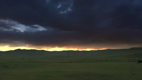 Mongolia sunset glows above grassland hills - Rolling Terrain and Scenic Plains Stock Footage 339706925