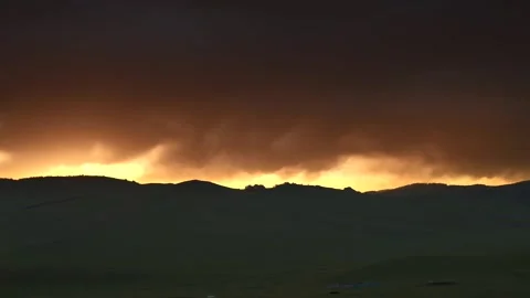 Mongolia sunset glows above grassland hills - Rolling Terrain and Evening Light Stock Footage 339706935
